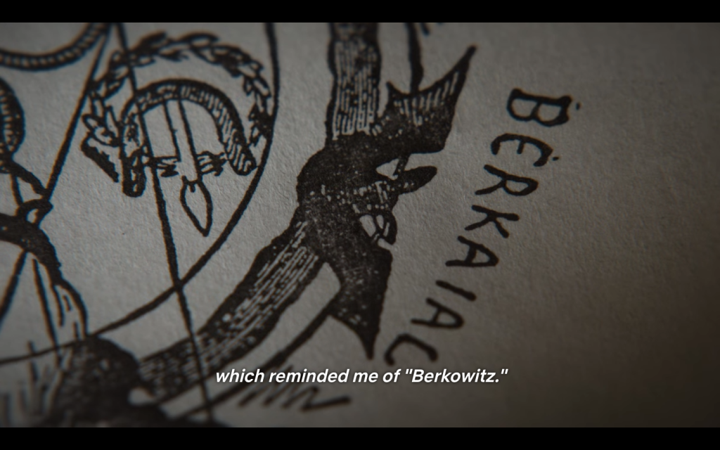 Another screen shot from the docuseries. A close-up of one of the words with the closed-caption text: "when it reminded me of 'Berkowitz'"